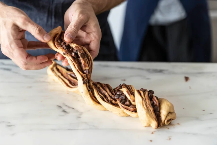 Image of Twist the two halves together, keeping the exposed chocolate layers...